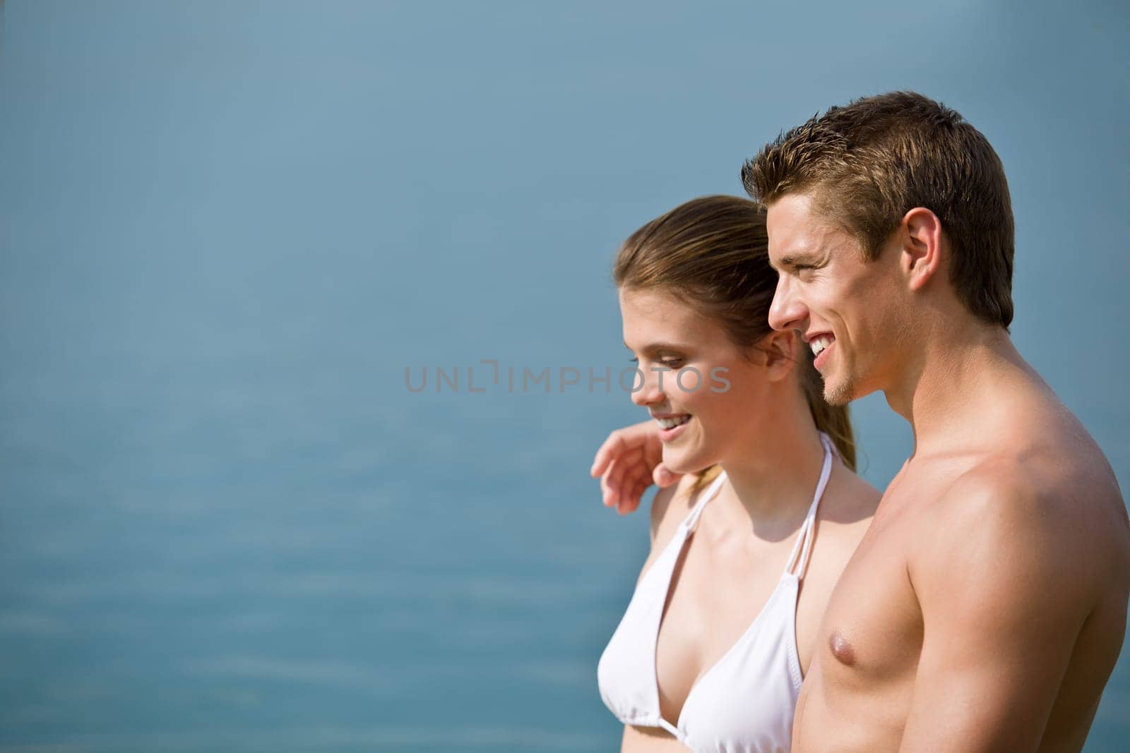 Couple in swimwear enjoy water and sun at sea