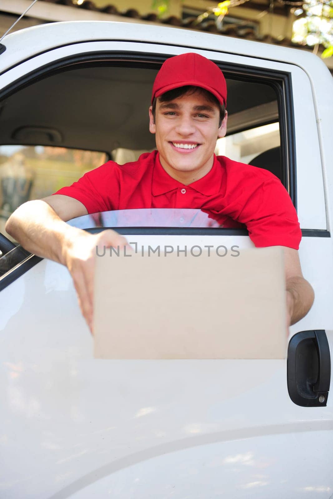 friendly parcel delivery man in a delivery car