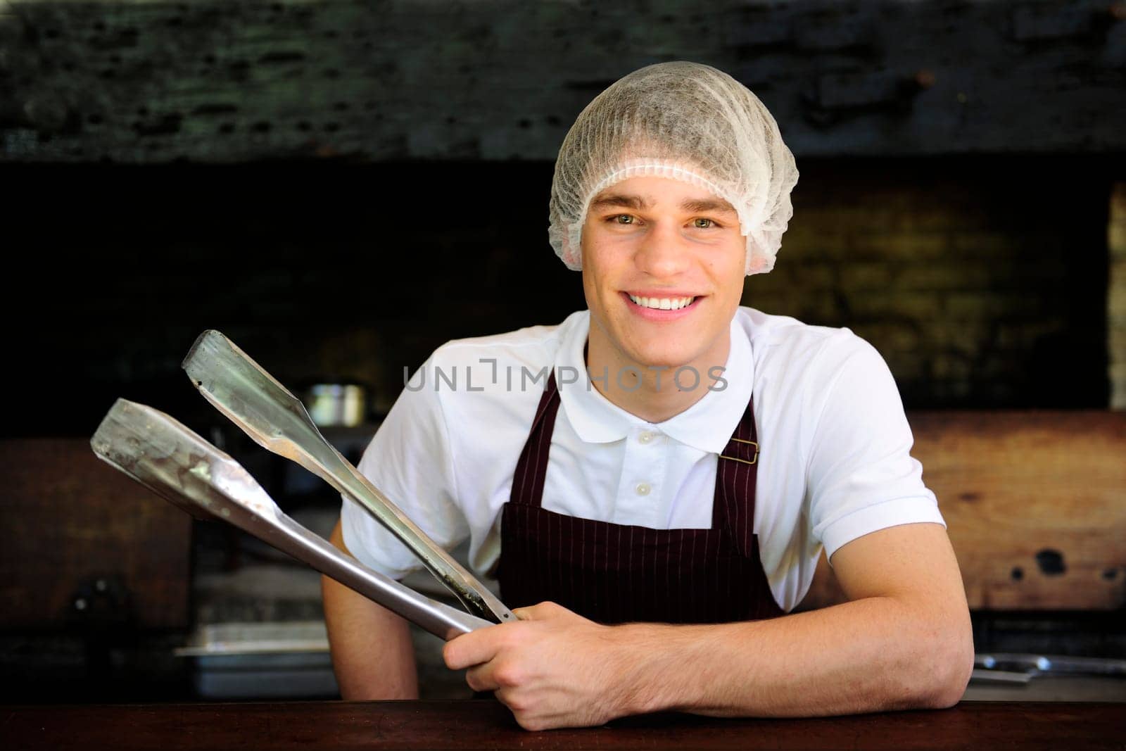 Man working in a restaurant with charcoal stove
