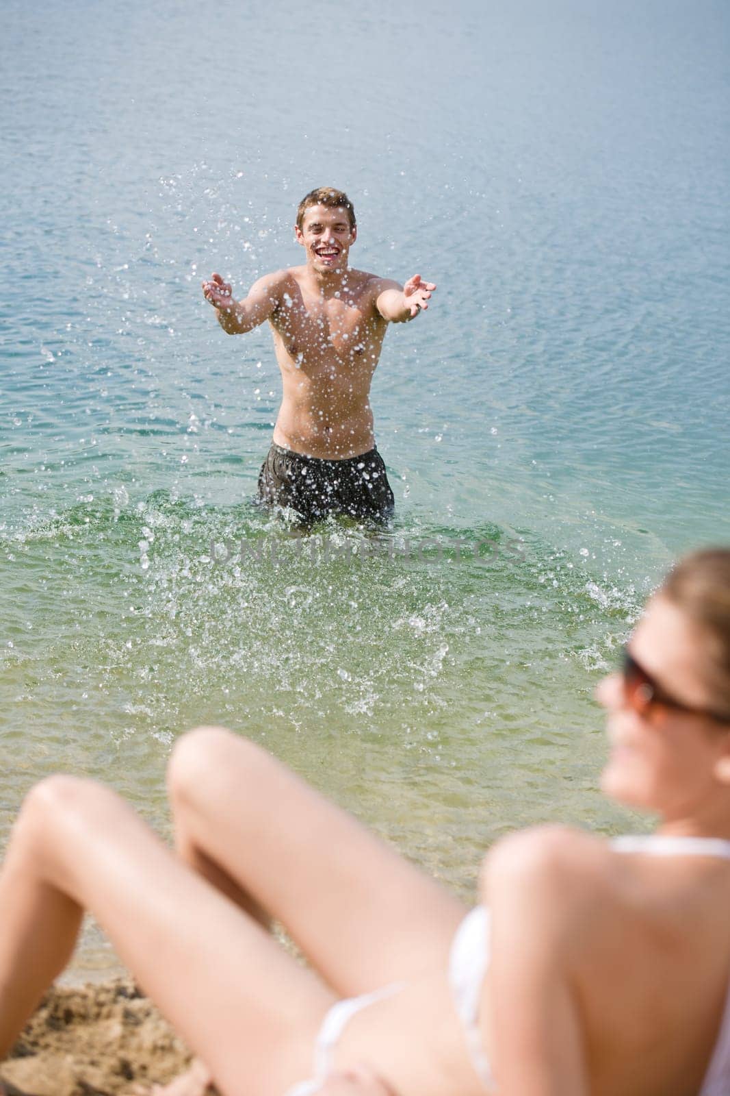 Couple enjoy sun and water on beach