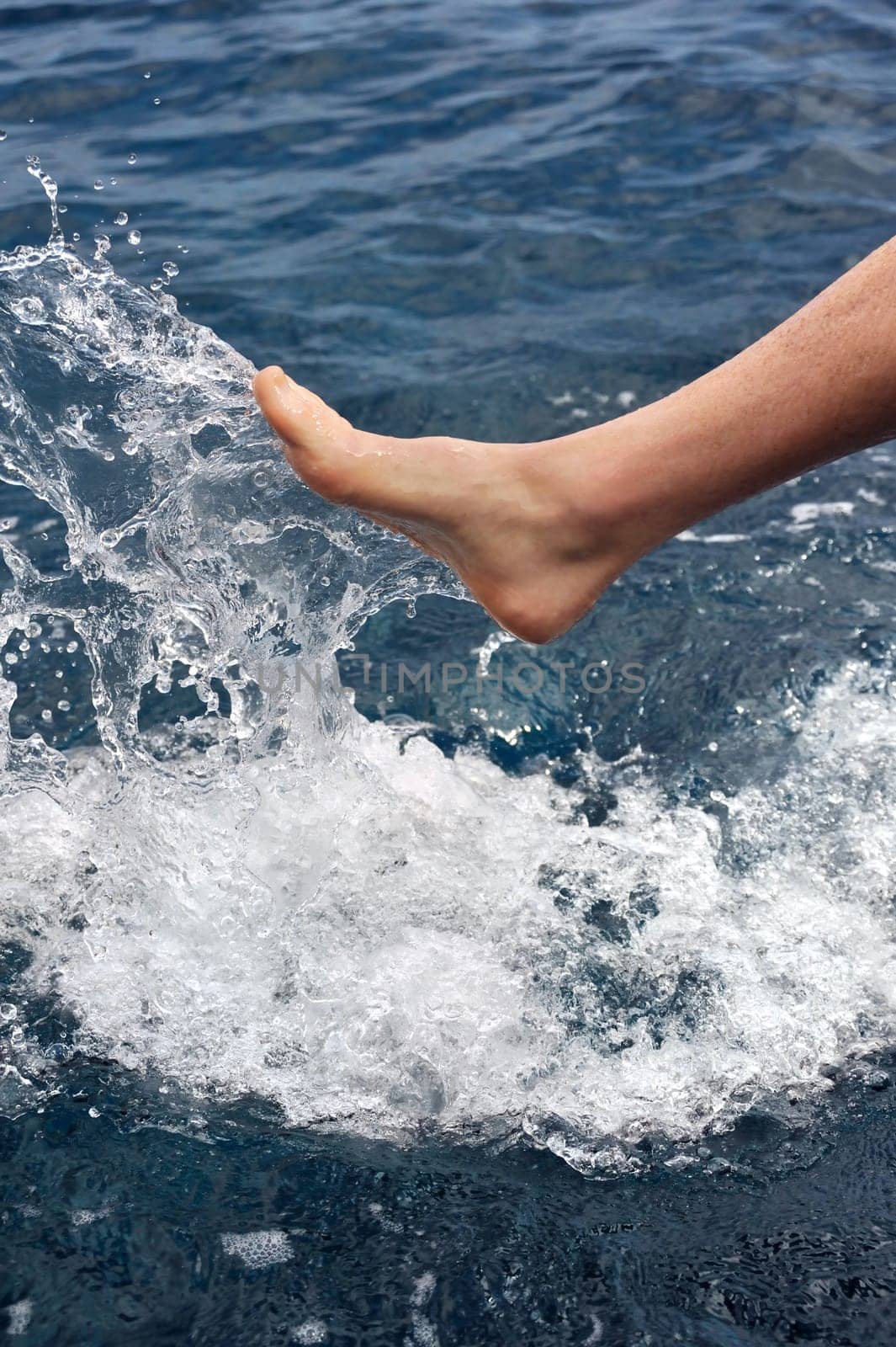 Foot of young man in water - splash