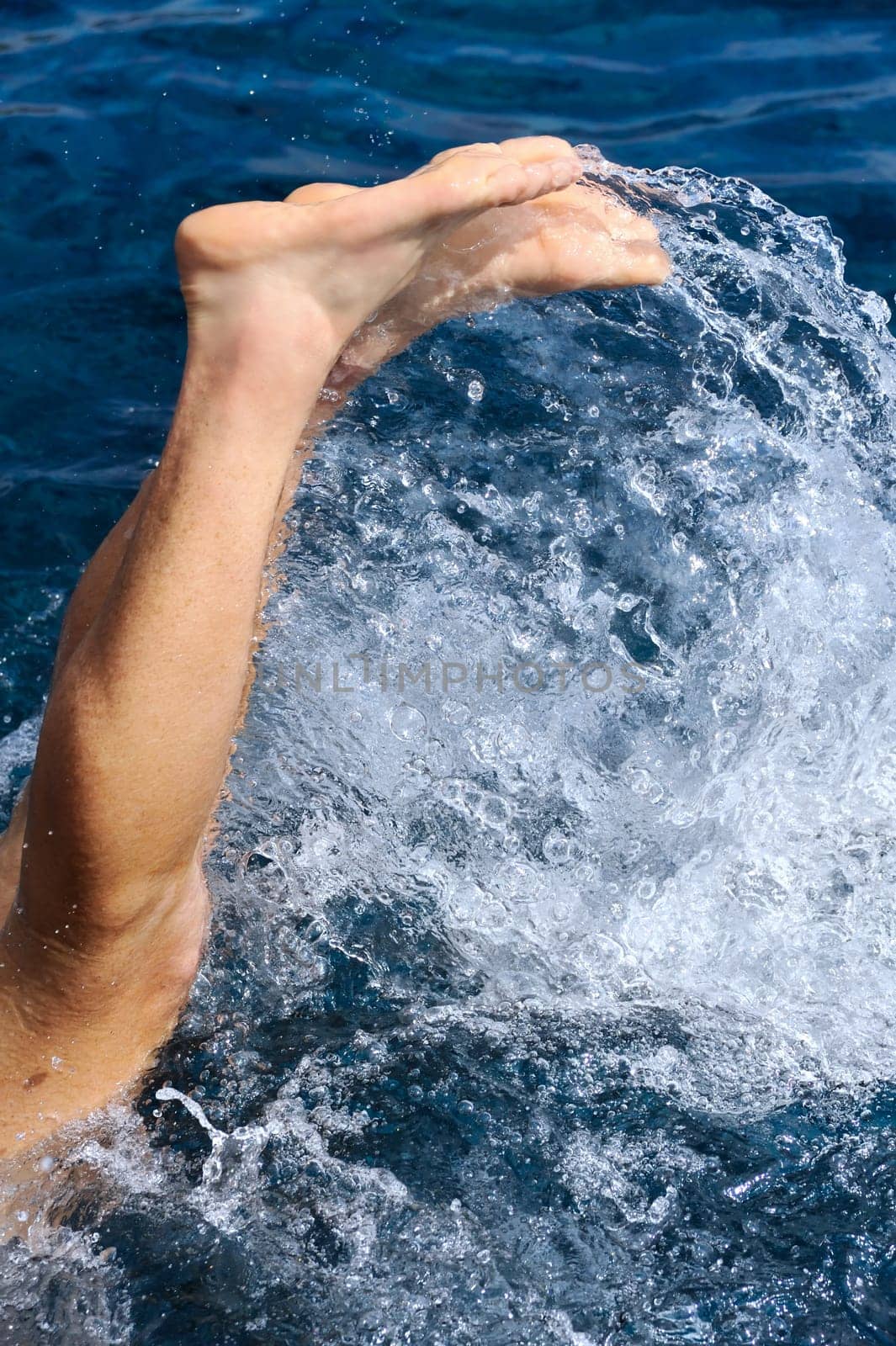 Young man jumping into water