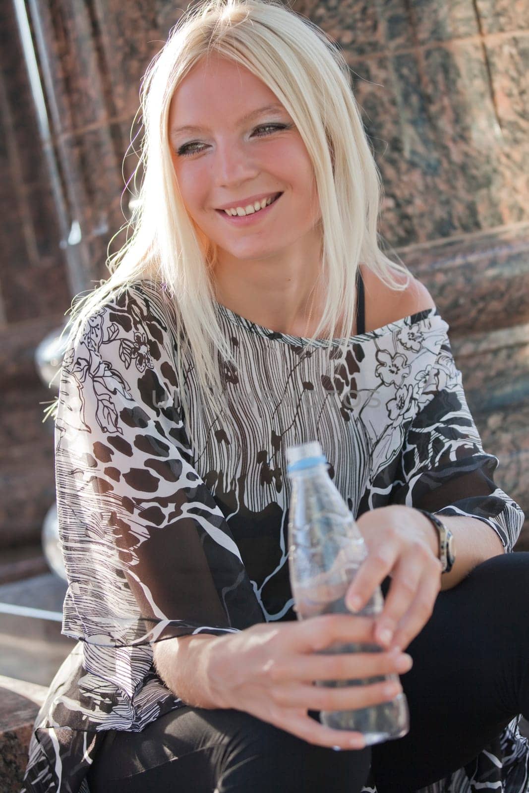happy woman with bottle of water