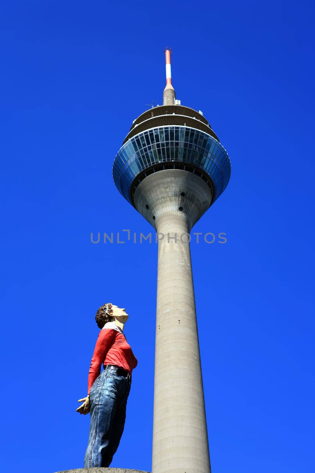 Figure looks up at the Rhine Tower