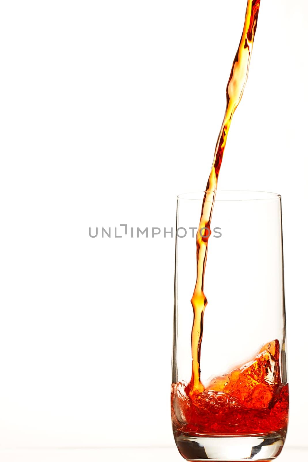 Red liquid flows into glass