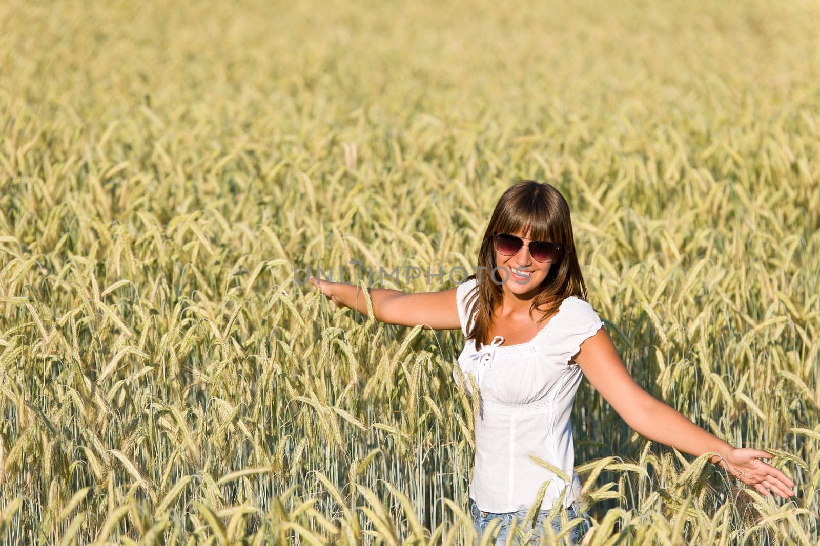 Happy woman in corn field enjoy sunset