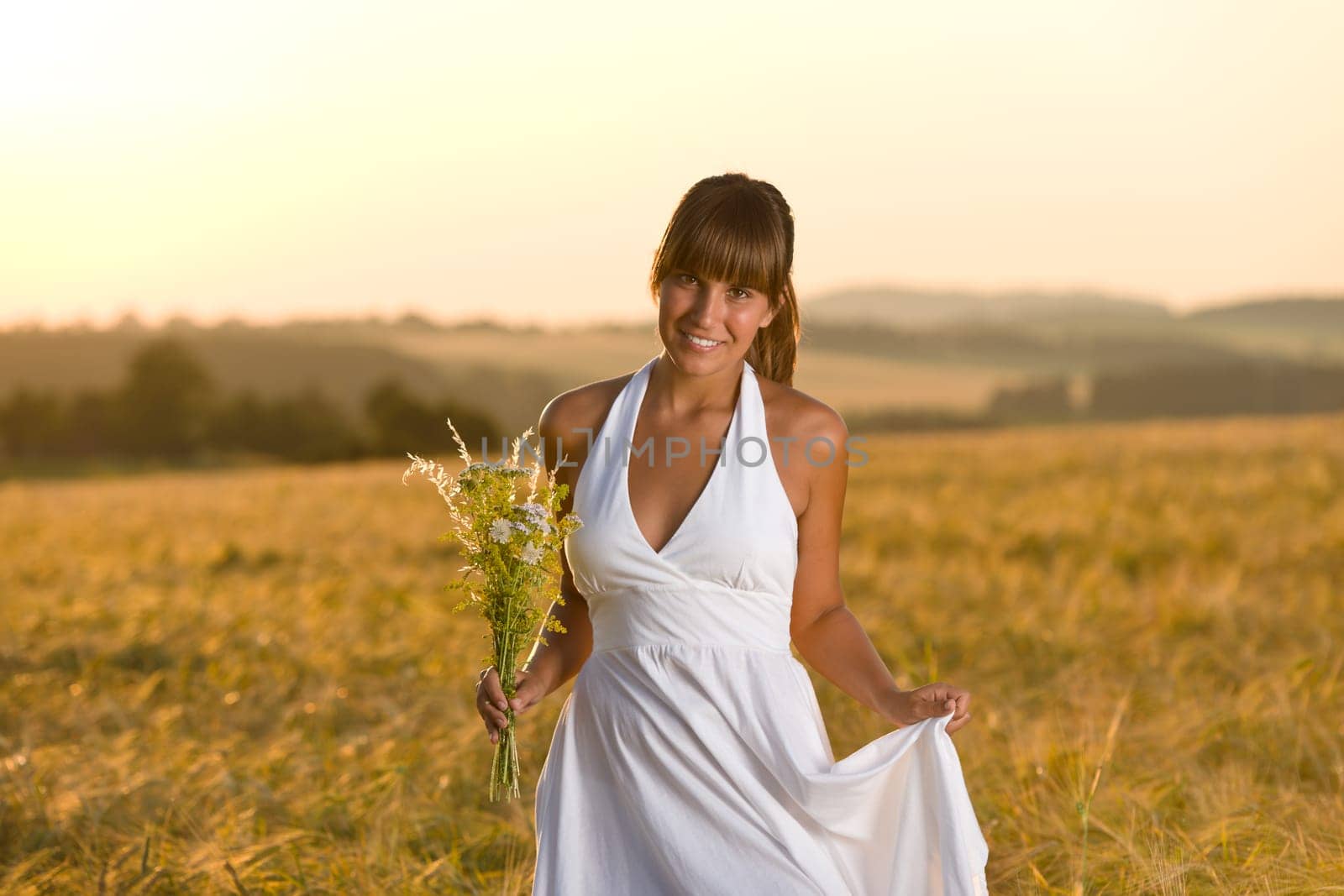 Romantic woman in sunset corn field wear dress