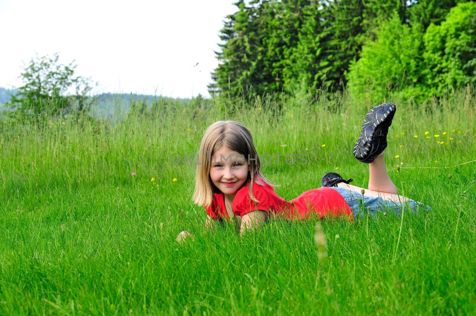 Child lying on meadow