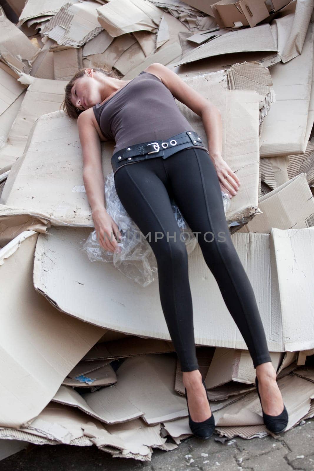 unconscious woman lying in cartons