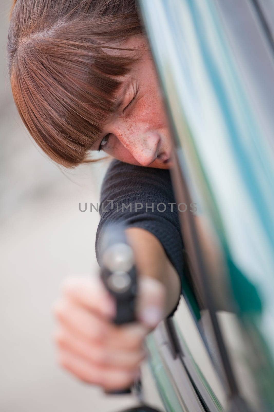 woman shooting from driving car