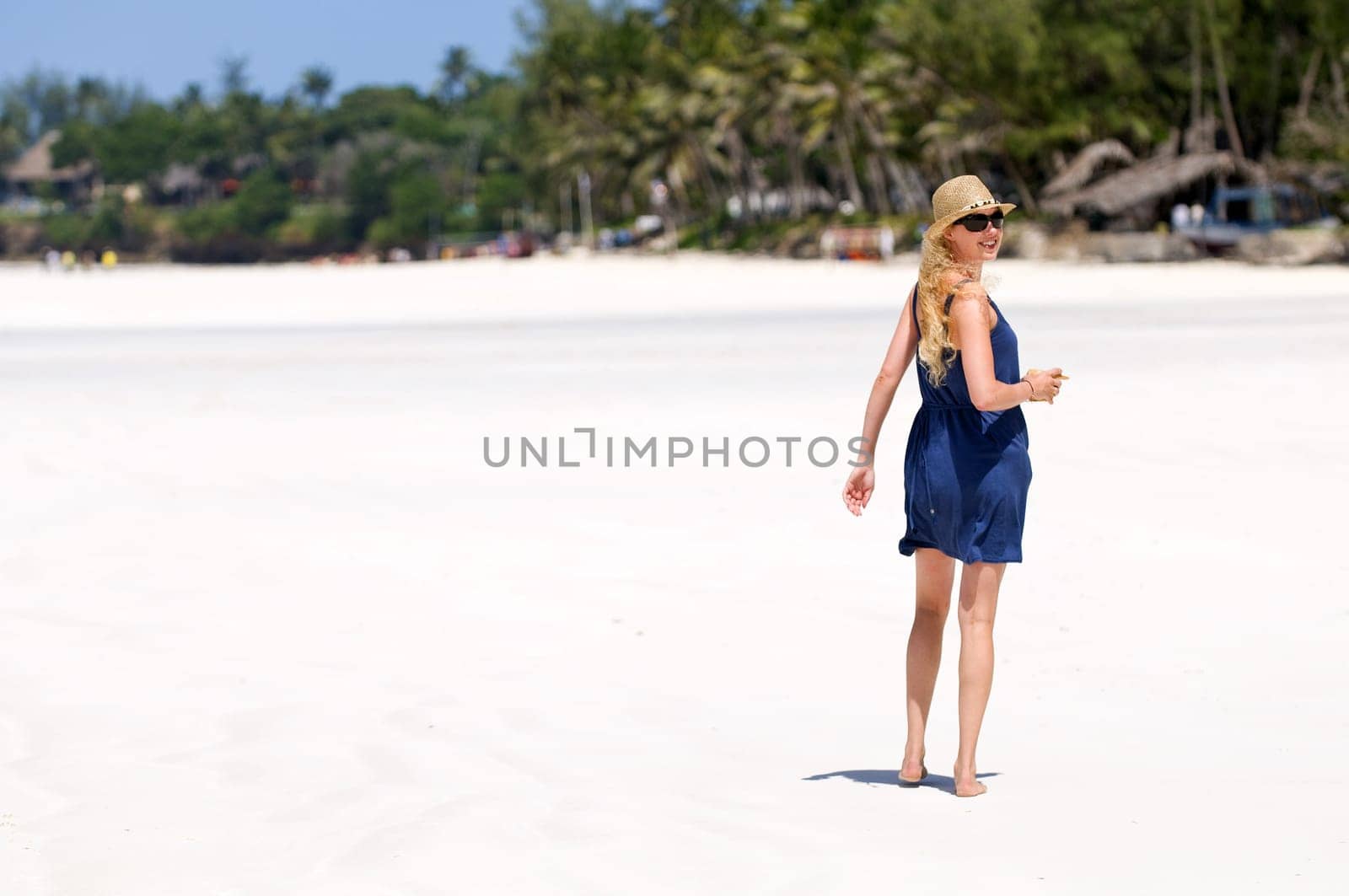 Young woman walking on the beach
