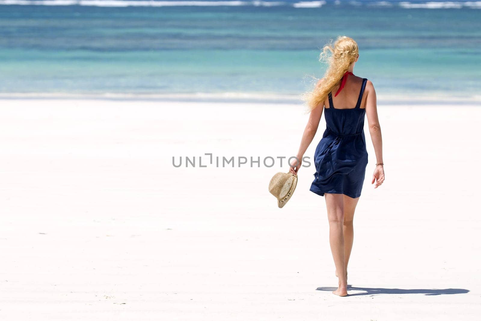 Young woman walking on the beach