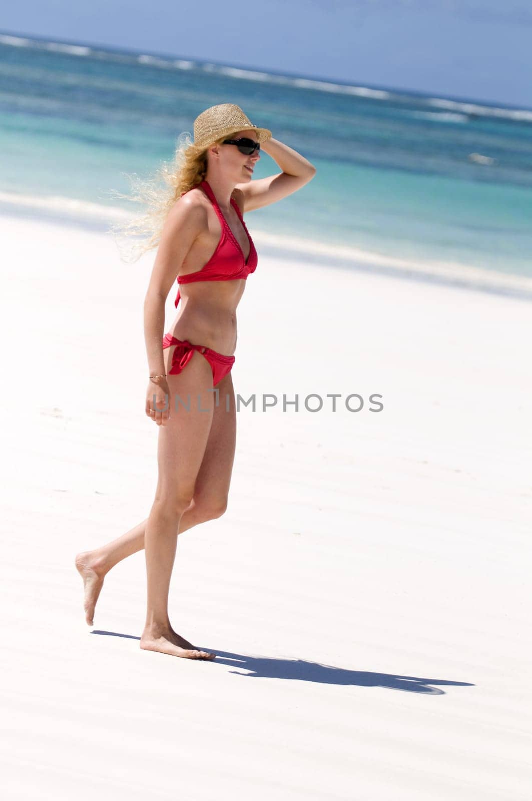 Young woman walking by the sea
