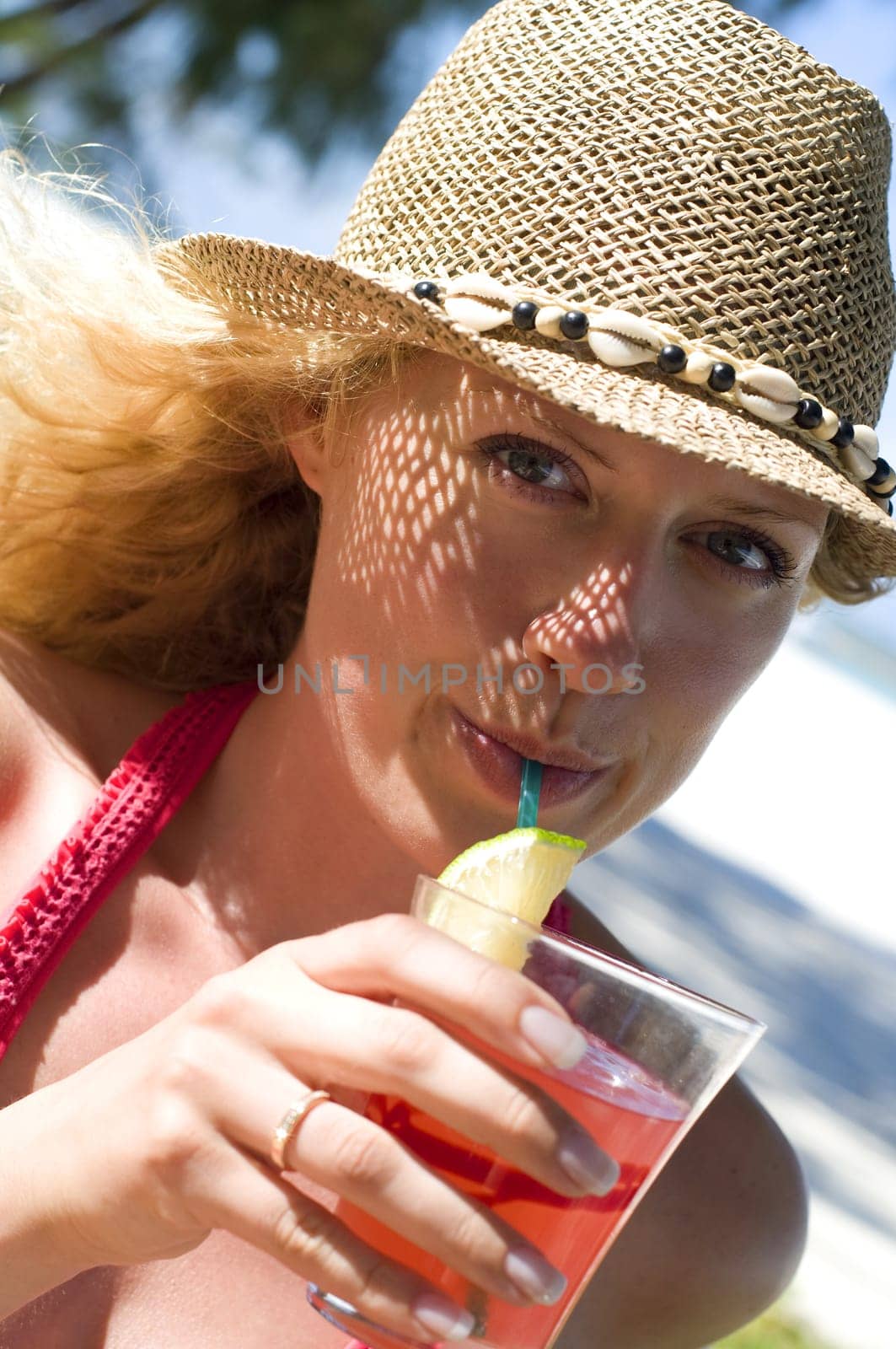 Woman with cocktail on the beach