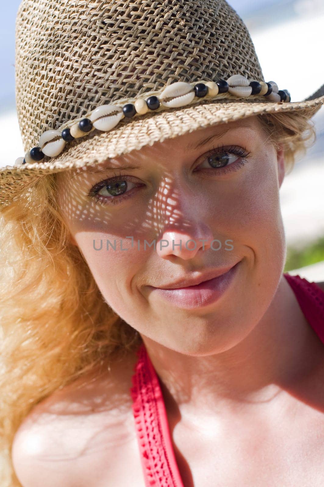 Woman with hat on the beach