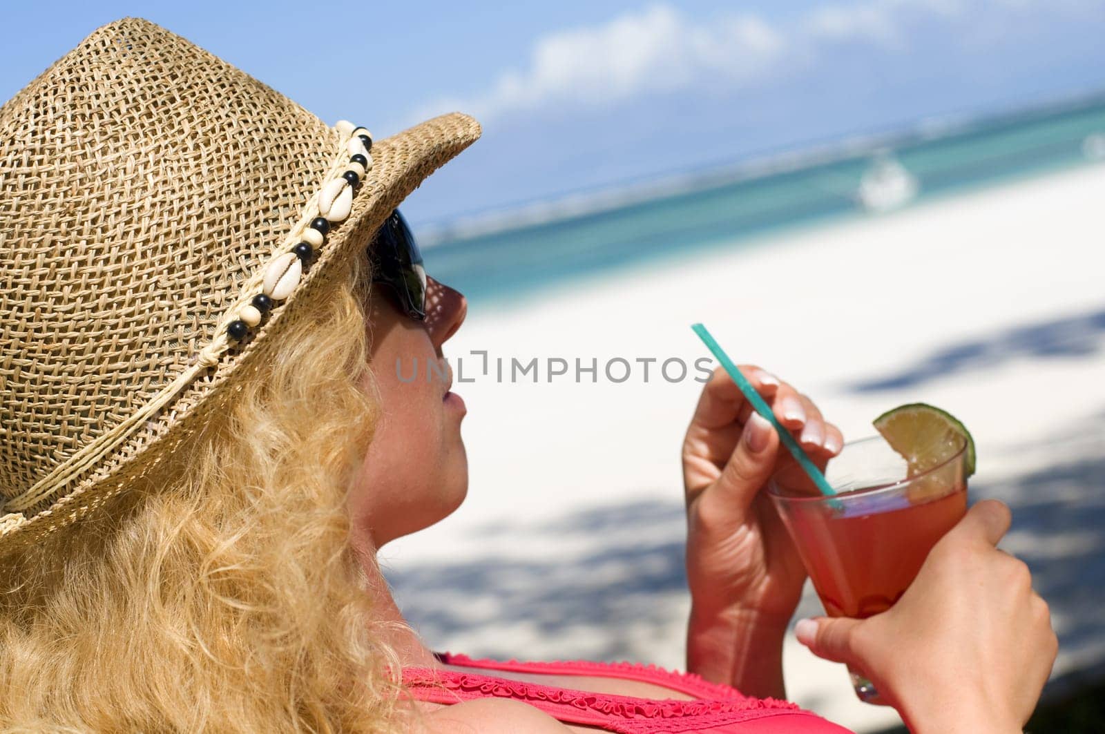 Woman with cocktail on vacation