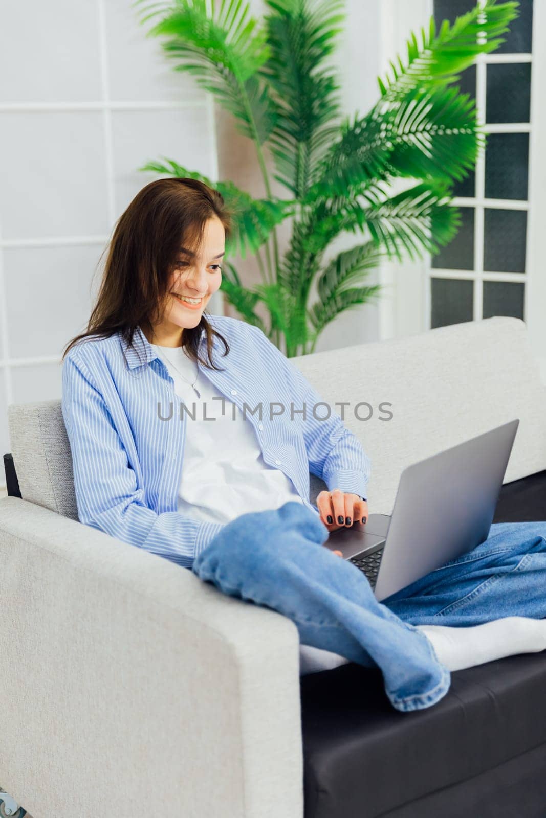 happy woman working at laptop computer in room remote work conversation on skype internet online communication