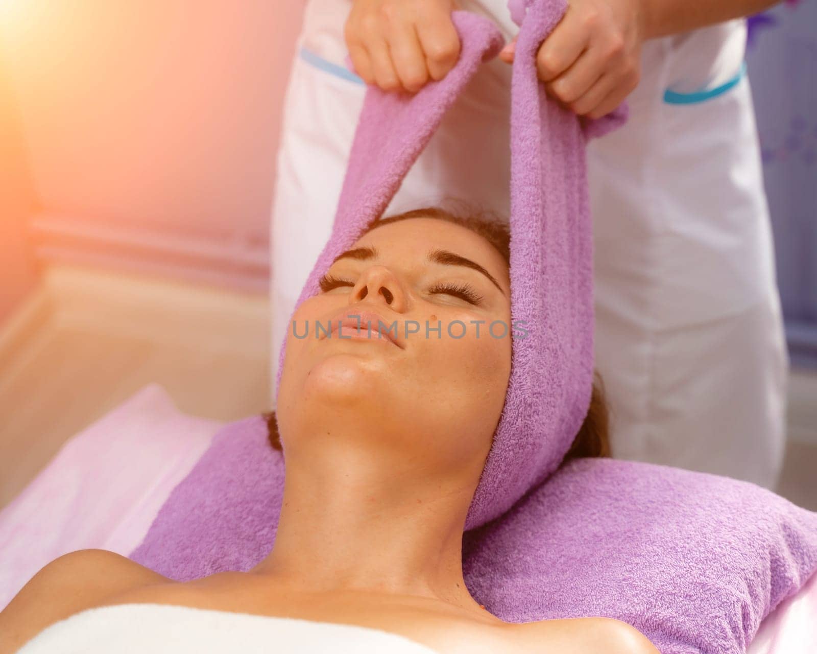 Relaxing massage. European woman getting head massage in spa salon, side view by Matiunina