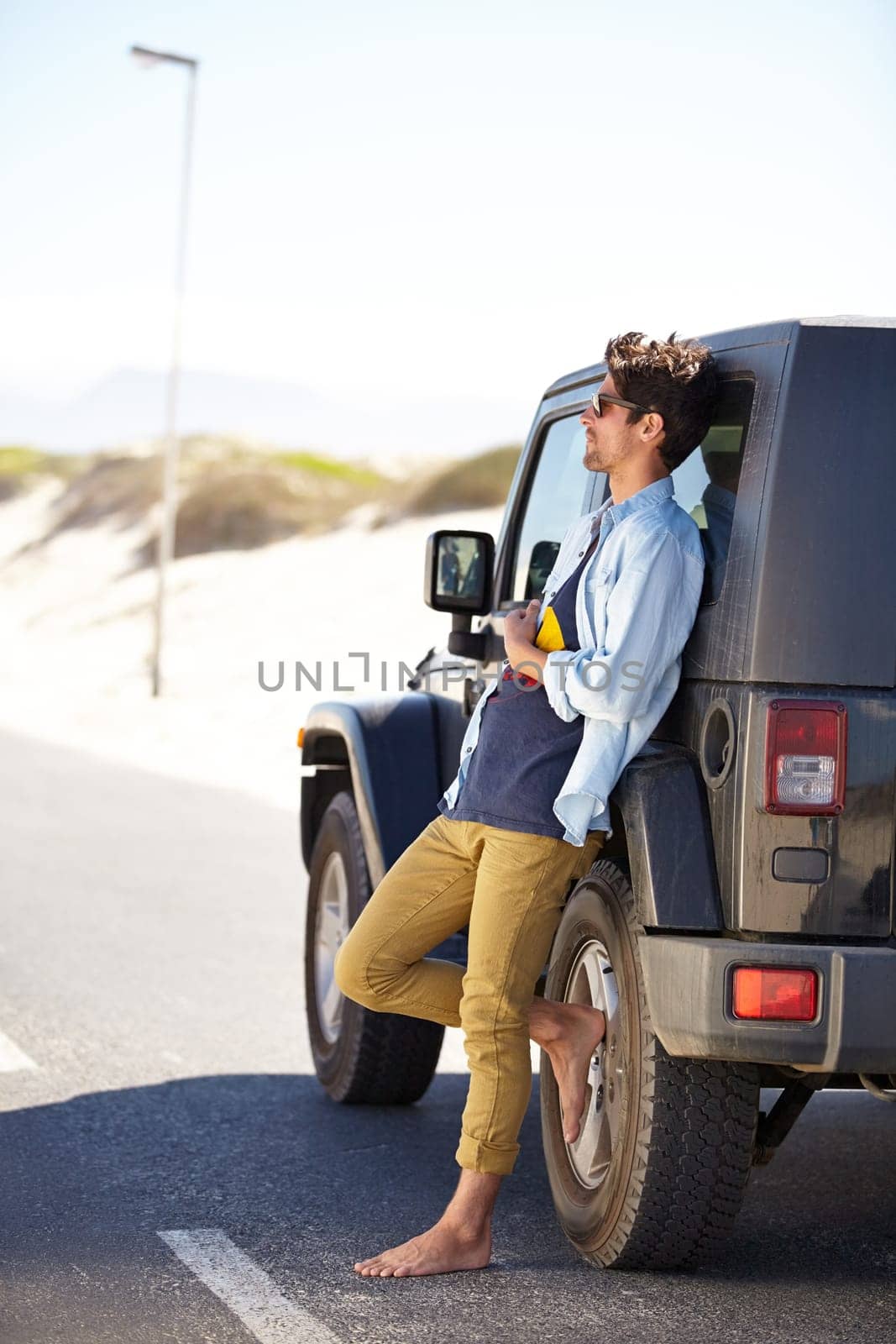 Car road trip, travel and outdoor man relax on road journey, summer adventure or street transportation on vacation tour. Moving automobile, driver freedom and person leaning on SUV, van or vehicle by YuriArcurs