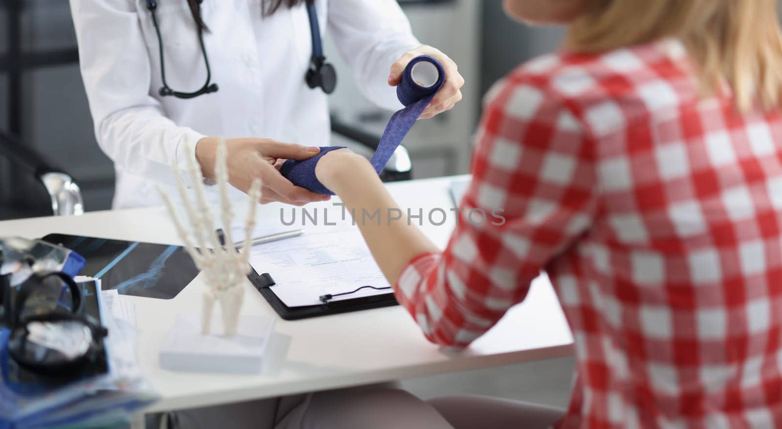 Close-up of physiotherapist applying bandage on patient hand, post traumatic rehabilitation, sport physical therapy, medicine, healthcare, recovery concept