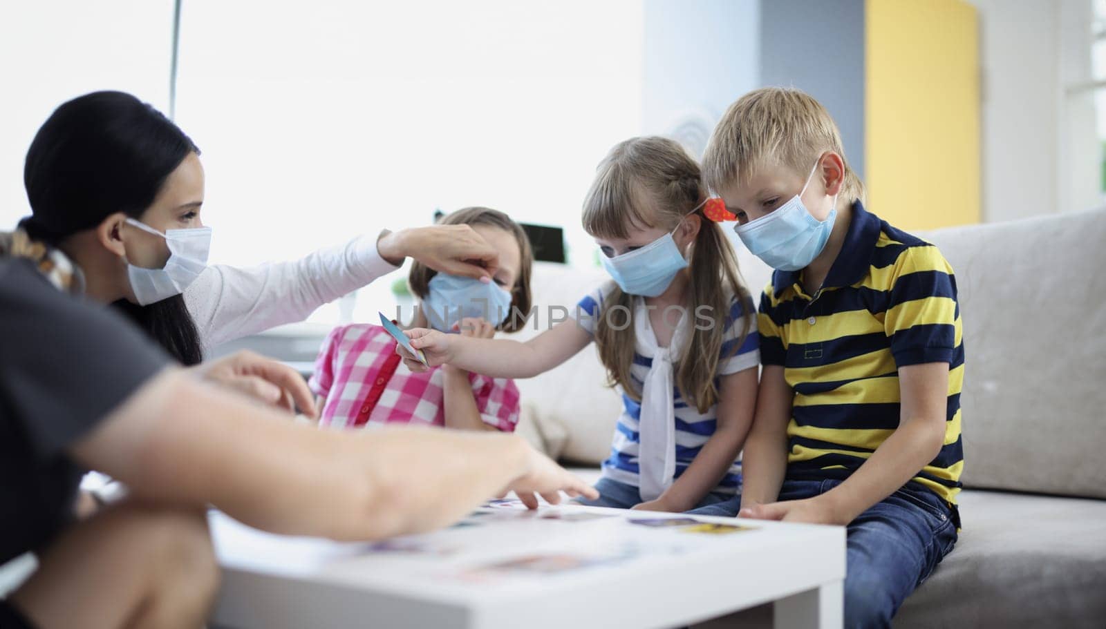 Woman keep checking on kids health, ask to wear face mask, prevent covid spread by kuprevich
