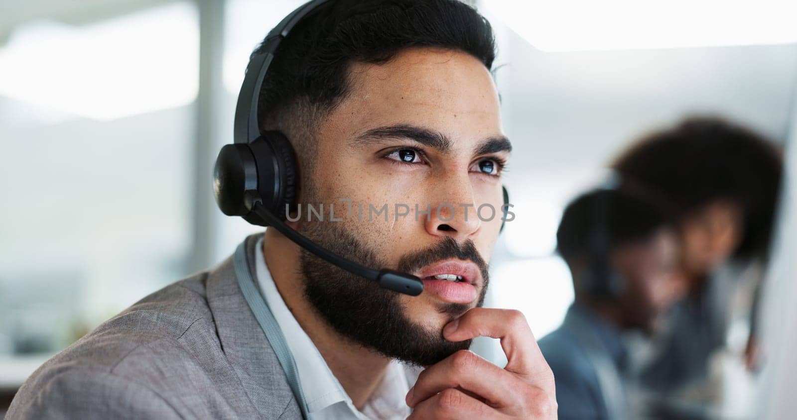 Employee, customer service and working in call center, thinking and Indian man with consulting. Receptionist, technology and communication with crm, corporate and telemarketing in office environment.