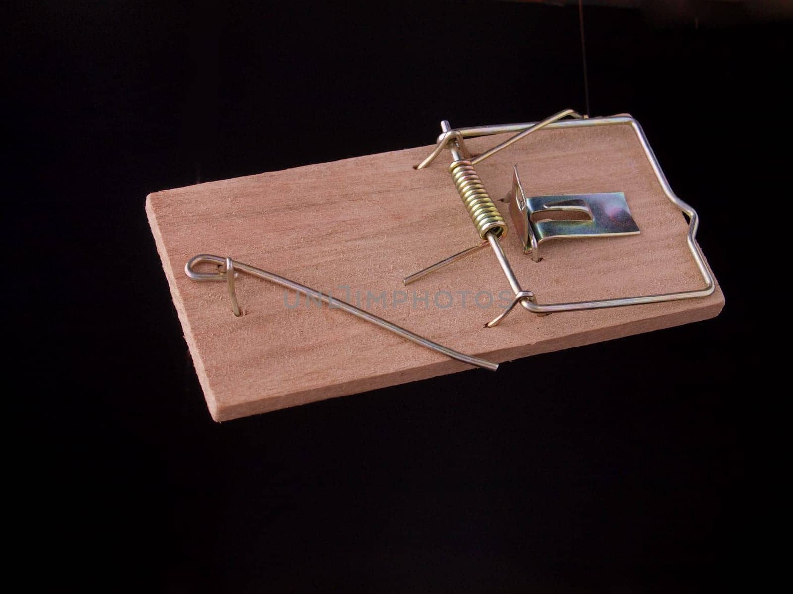 Mouse trap on a plain black background