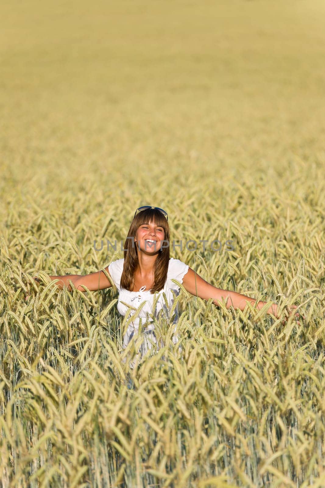 Happy woman in corn field enjoy sunset