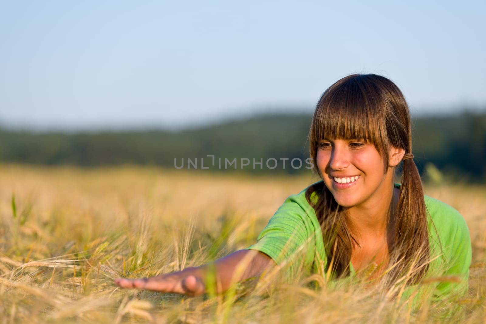 Young woman in sunset corn field