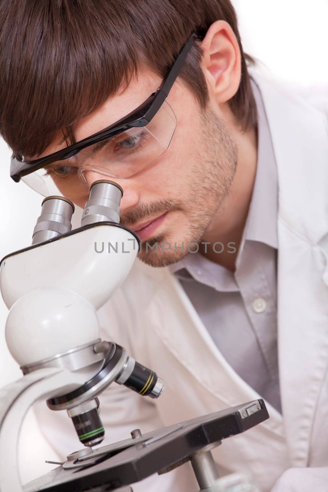 researcher looking in microscope