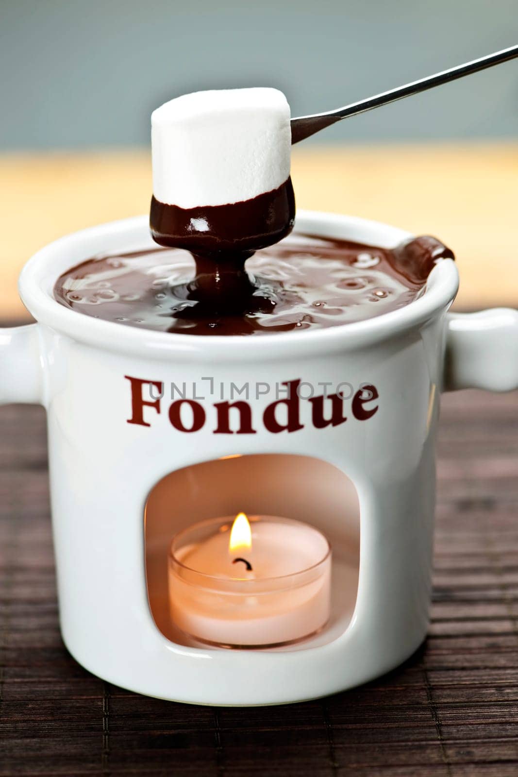 Marshmallow dipped in chocolate fondue