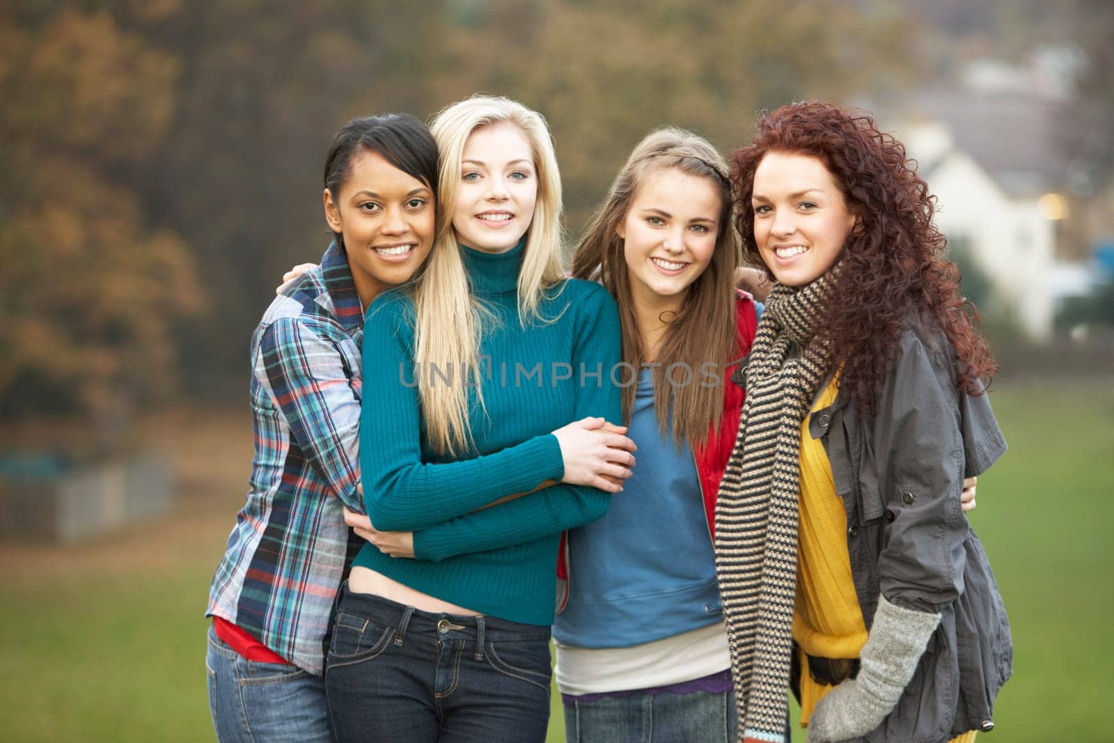 Group Of Four Teenage Girls In Autumn Landscape