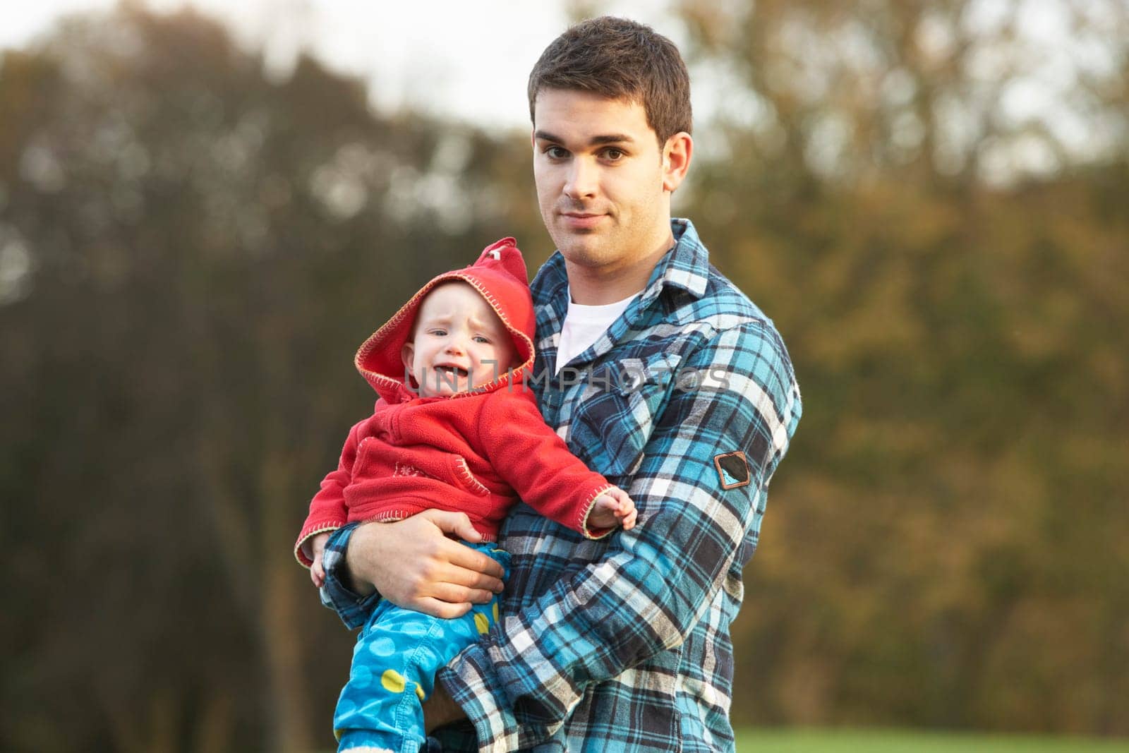 Shocked Teenage Boy Holding Baby