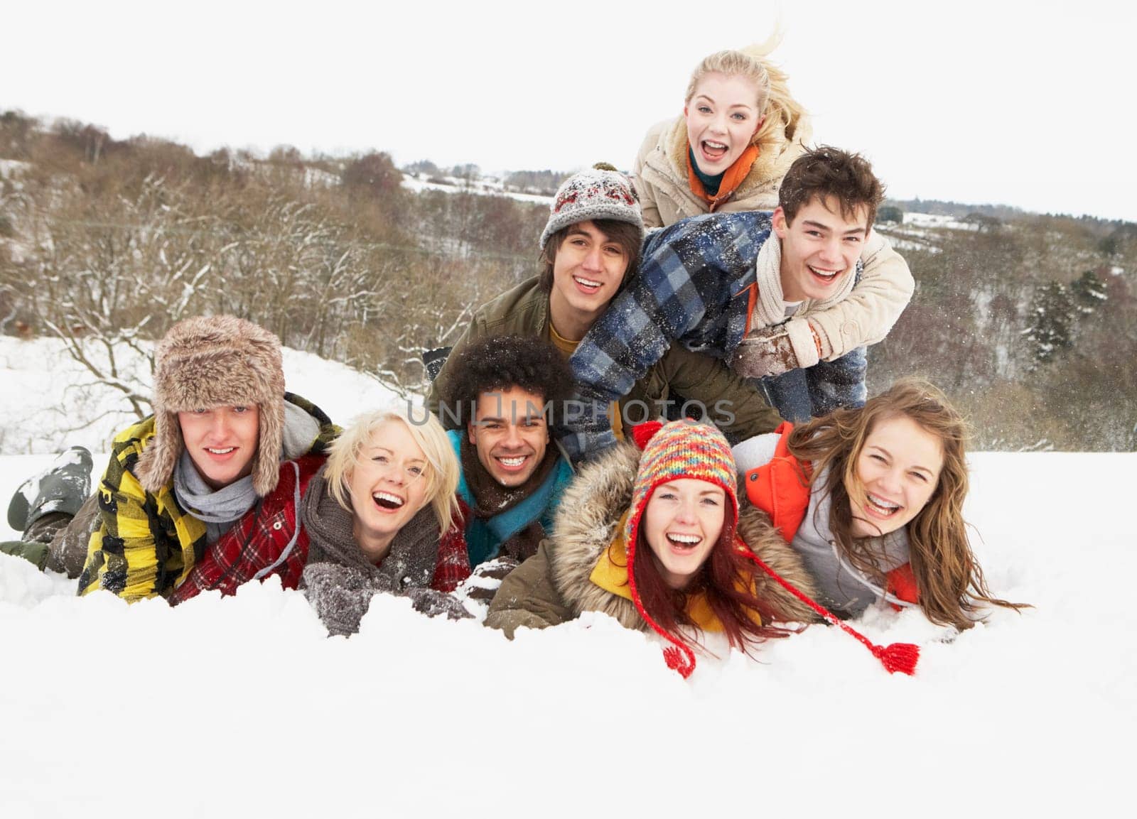 Group Of Teenage Friends Having Fun In Snowy Landscape