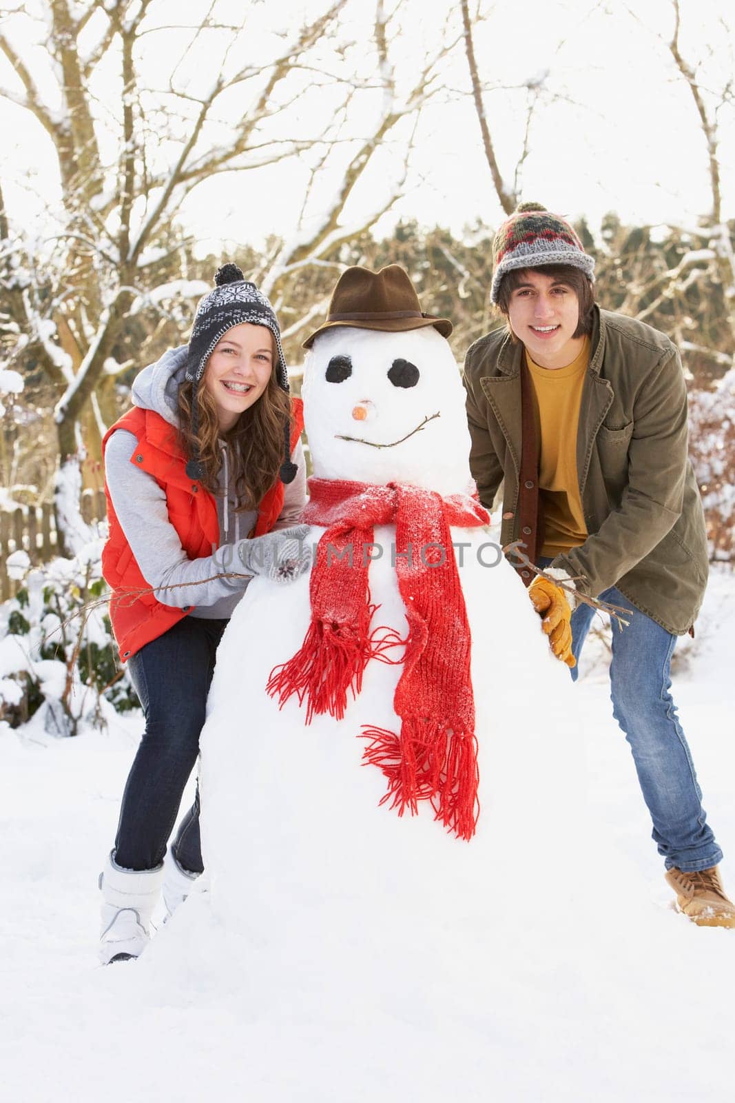 Teenage Couple Building Snowman
