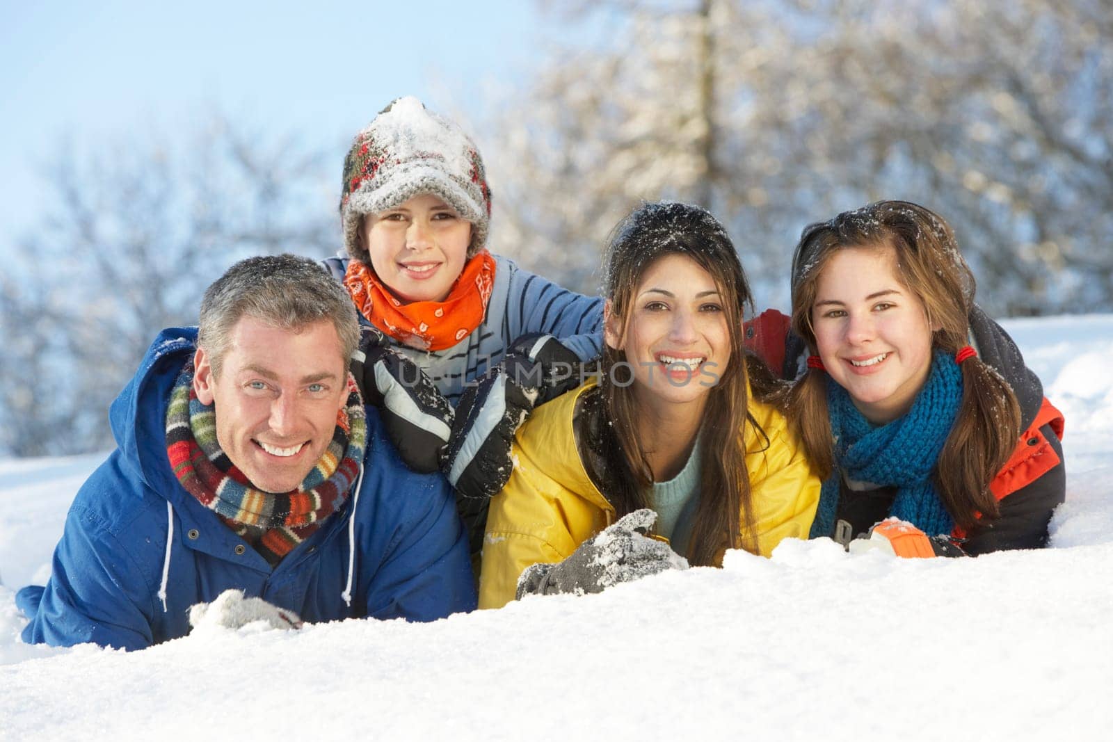 Young Family Having Fun In Snowy Landscape