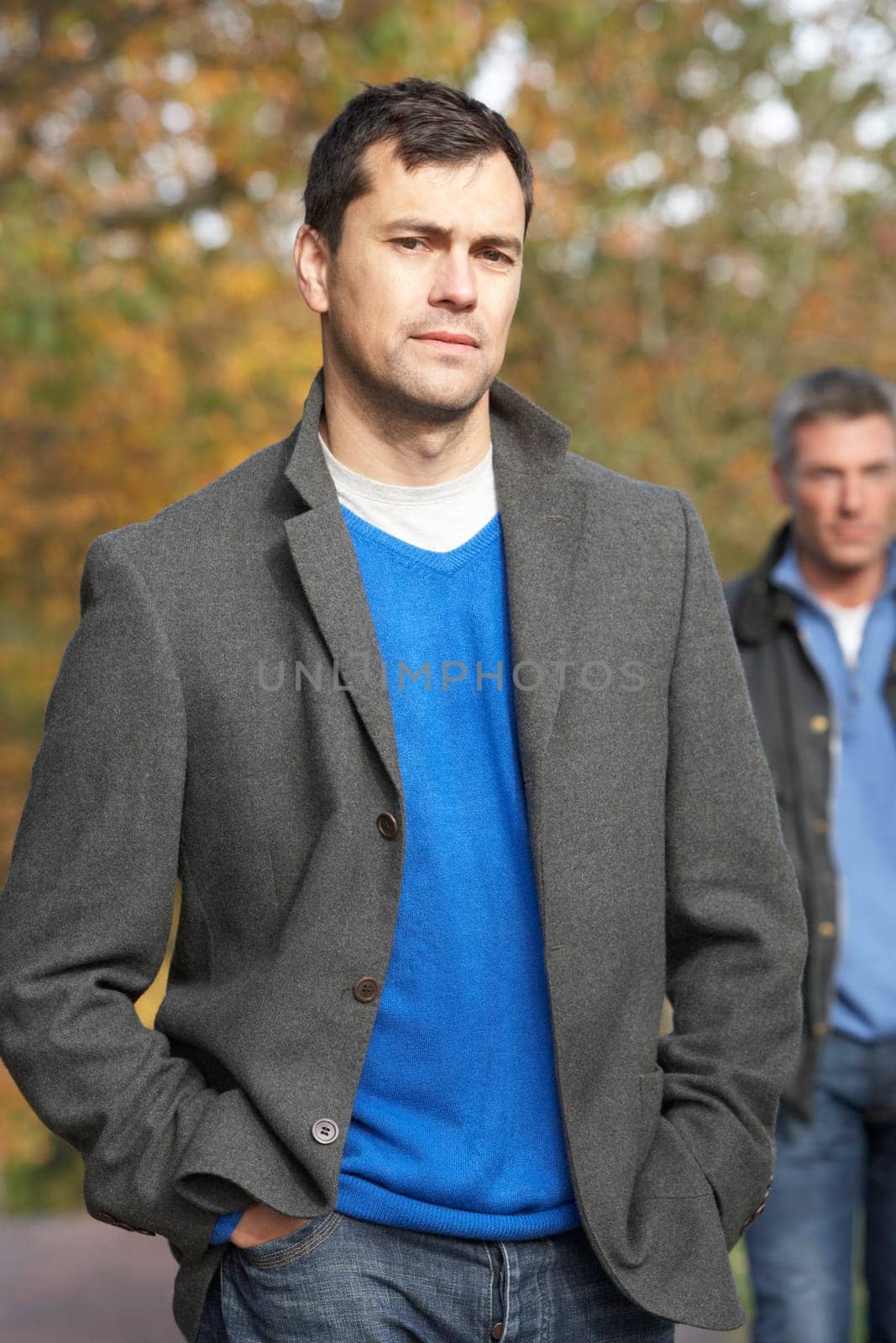 Two Men Standing Outside In Autumn Woodland