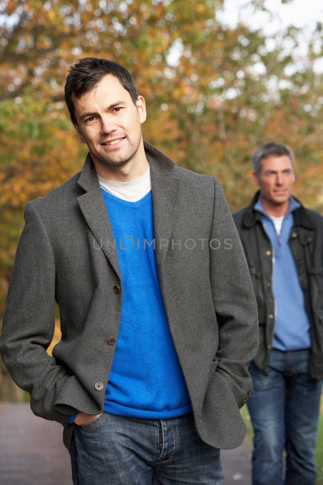 Two Men Standing Outside In Autumn Woodland