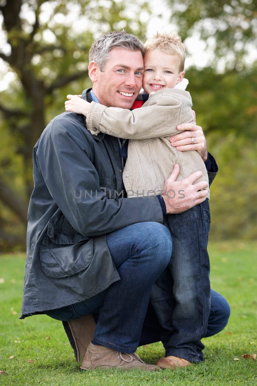 Father And Son Hugging On Outdoor Autumn Walk