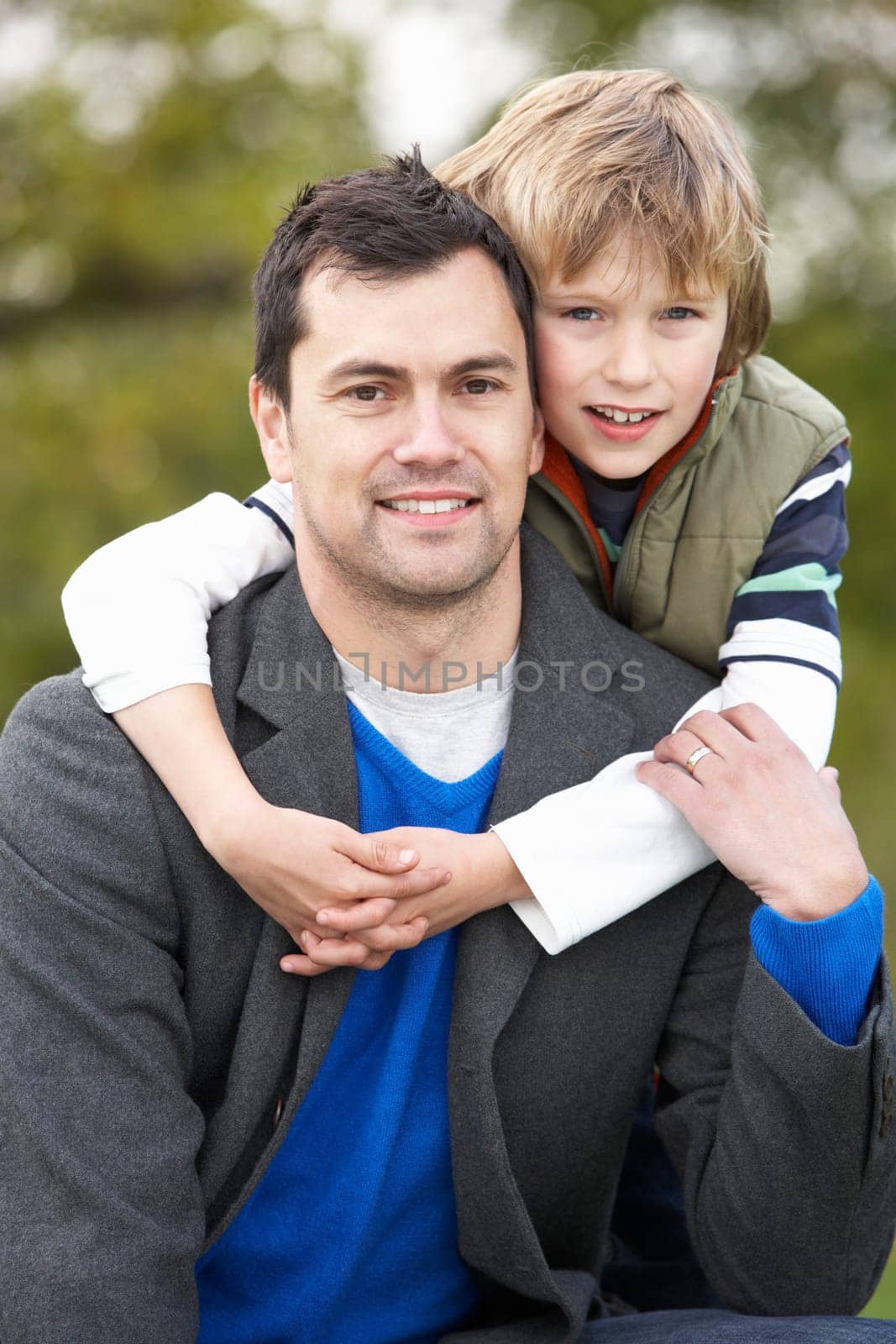 Father And Son Hugging On Outdoor Autumn Walk