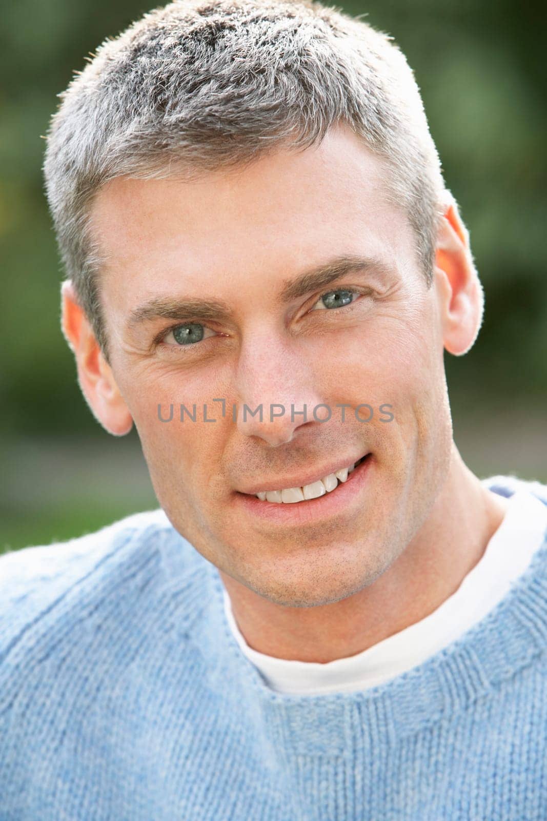 Close Up Portrait Of Man Standing Outside In Autumn Landscape