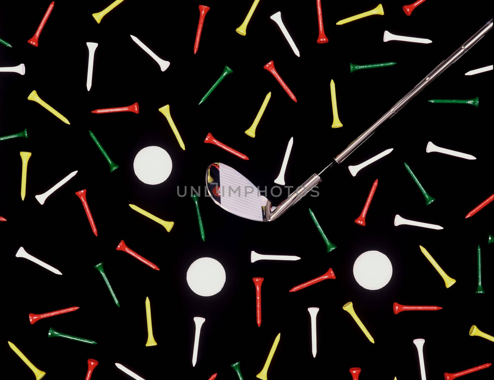 Golf club with balls and tees is shown in an overhead shot with a black background. Horizontal shot.