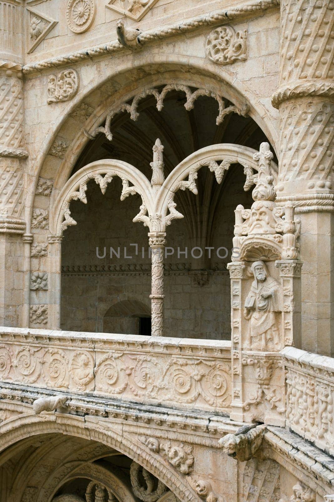 Arched ornate relief and statuary at the Monastery of Jeronimos in Lisbon, Portugal. Vertical shot.