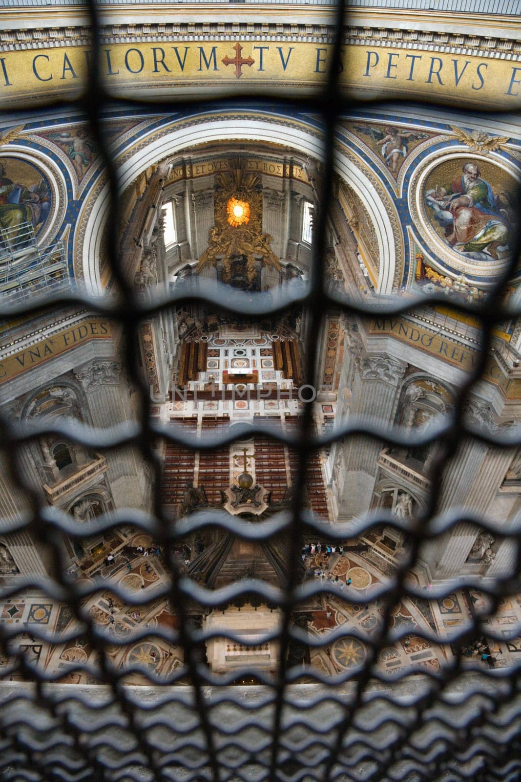 Altar in St Peter's Basilica seen through fencing. Vertical shot.