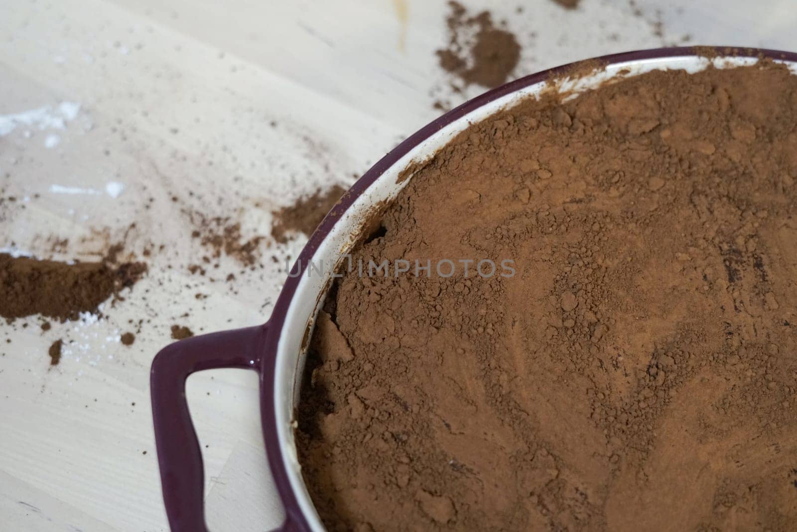homemade tiramisu cake dessert with cocoa powder on top and poured spilled on wooden table messy family home cooking together cozy evening tea . High quality photo
