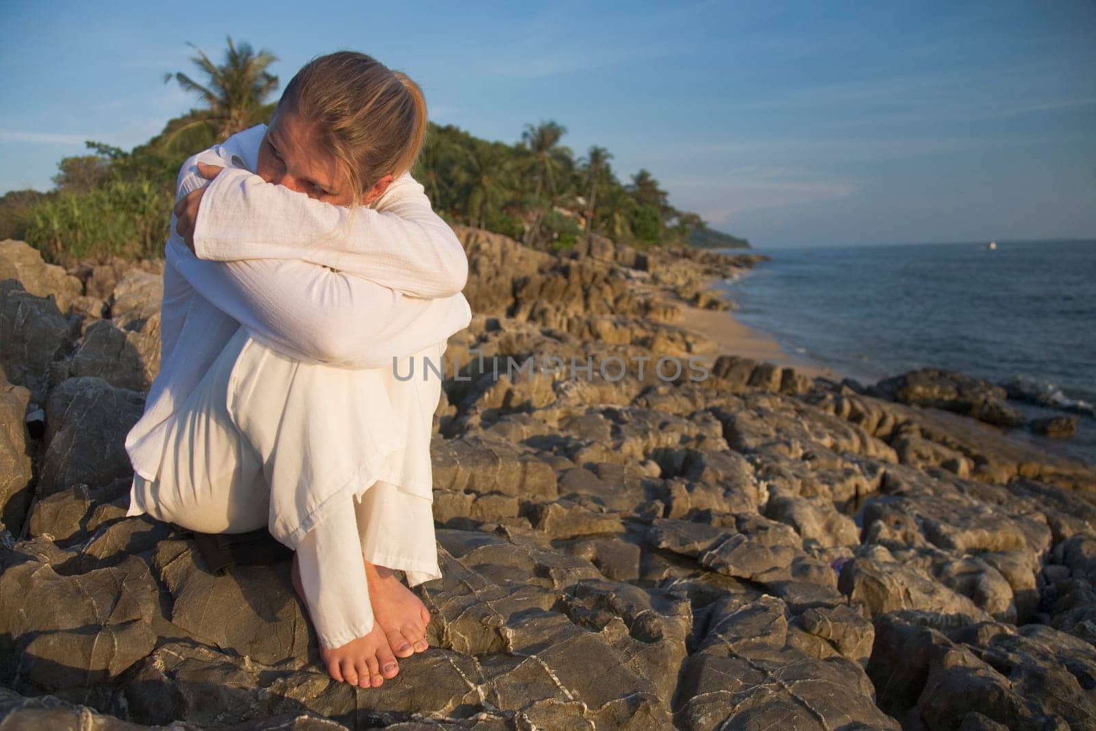 Woman on rocky shoreline