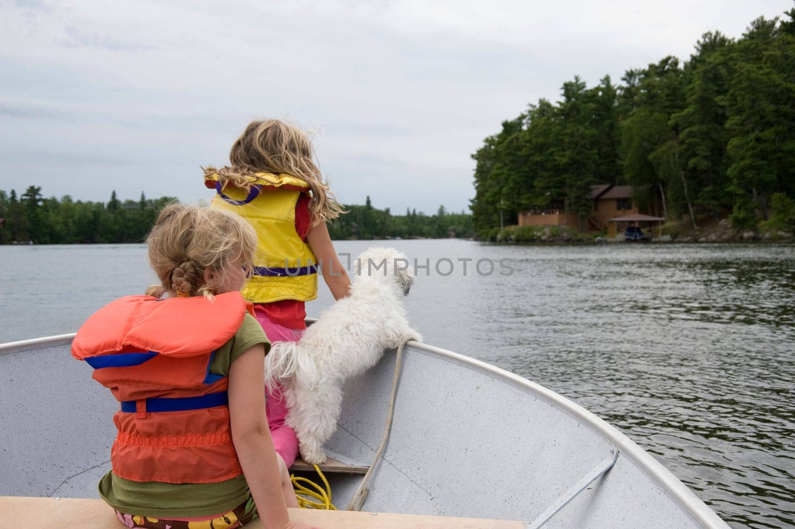 Children in boat with dog, Lake of the Woods, Ontario, Canada