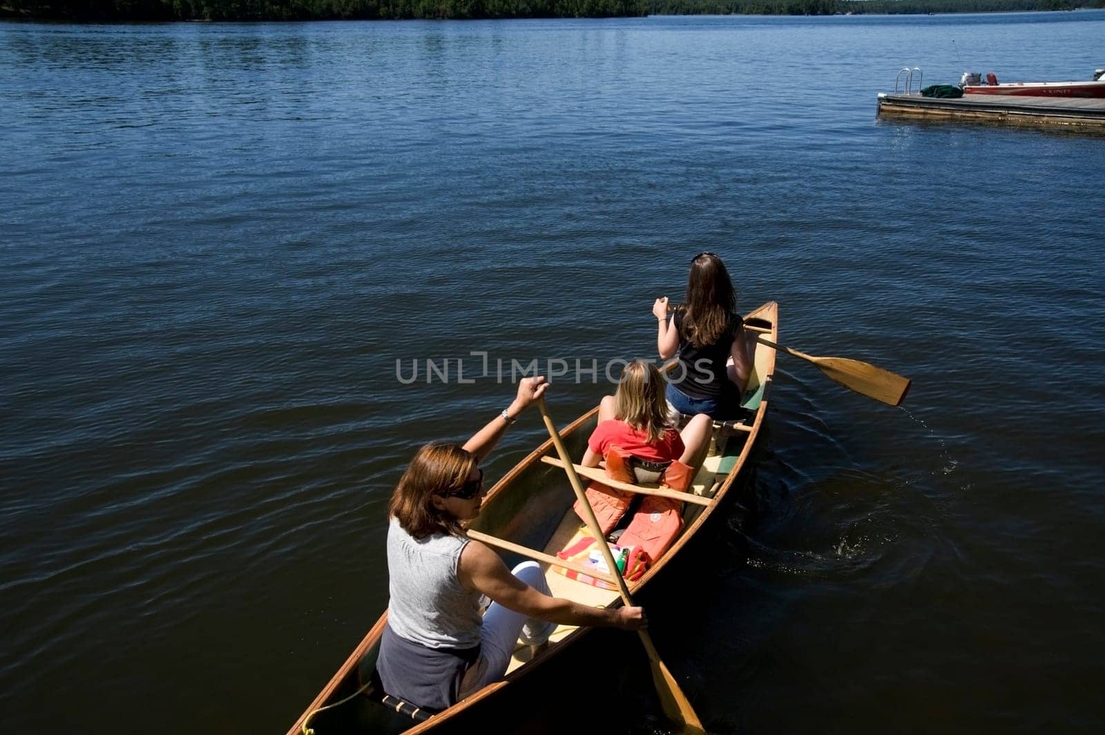 Family canoeing on lake, Lake of the Woods, Ontario, Canada