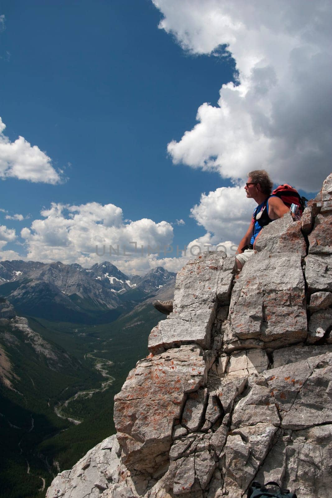 Man sitting on a mountain top enjoying the view