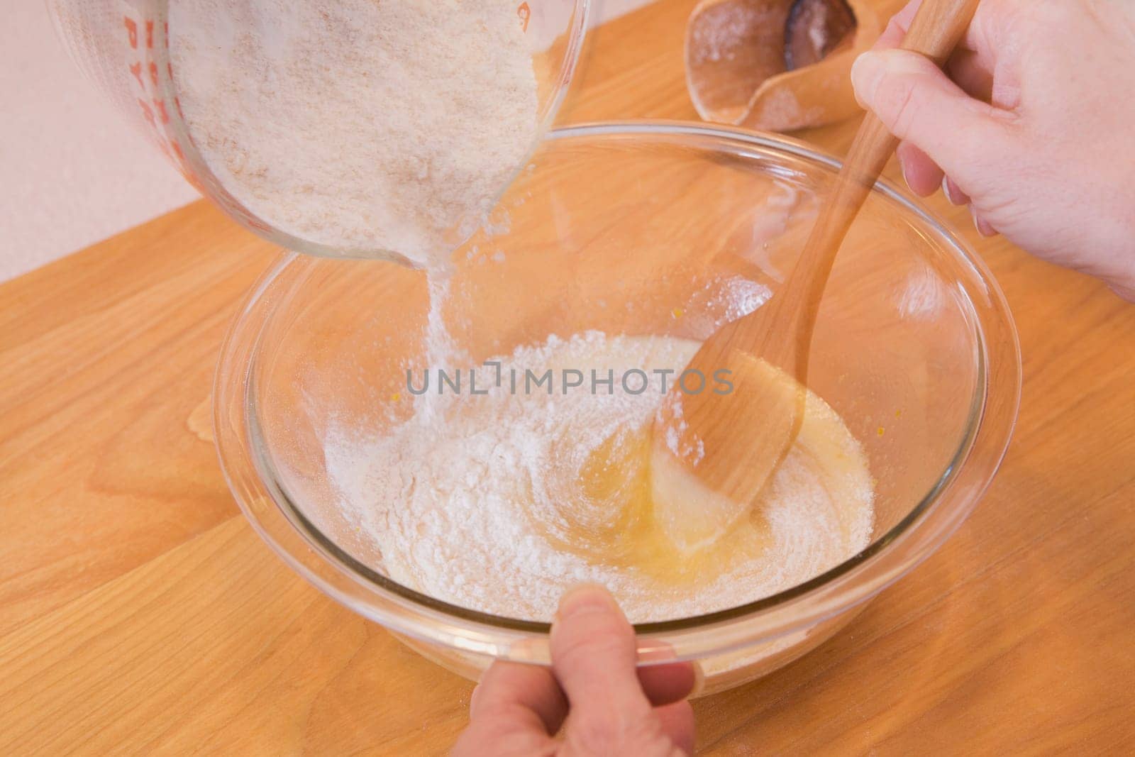 person mixing ingredients into a bowl